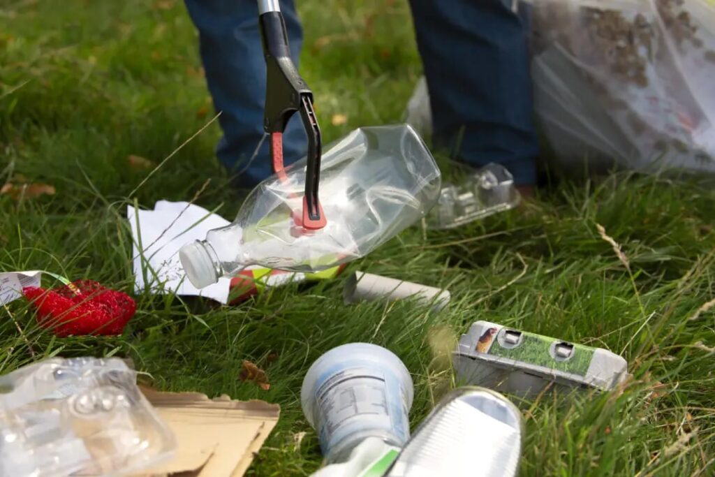 Person collecting trash outdoors