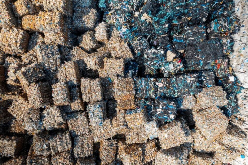 Compressed bales of plastic scrap outside a recycling facility
