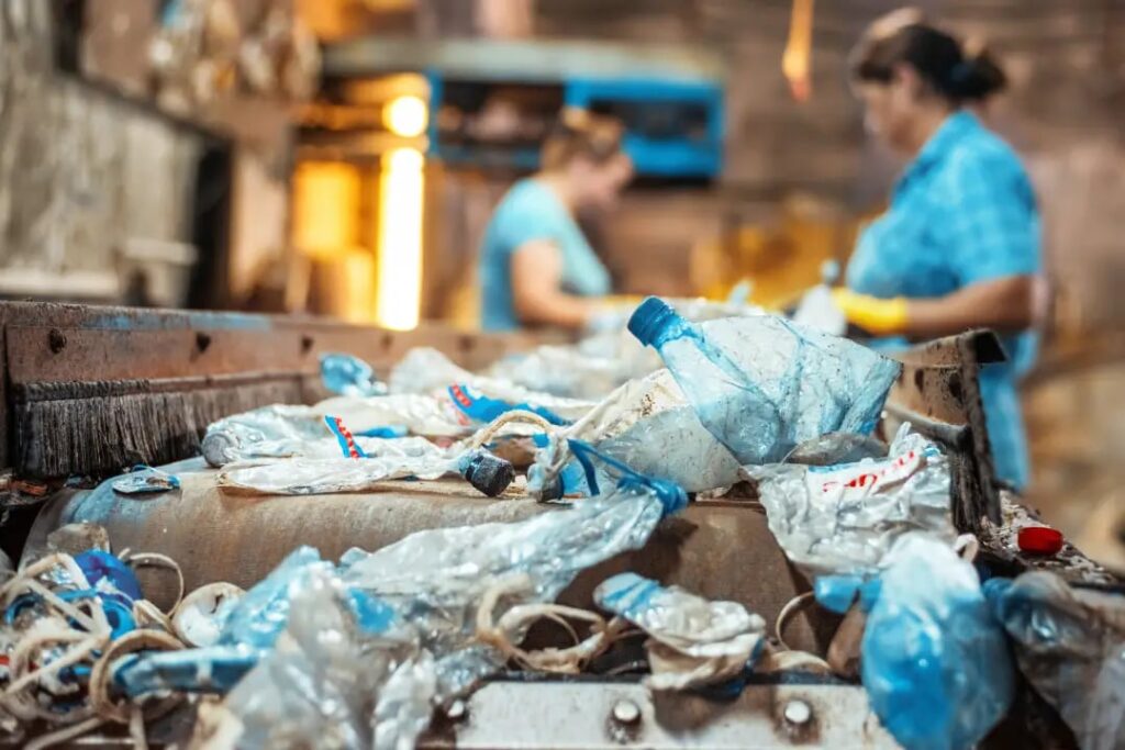 Plastic waste on a conveyor belt at a recycling plant
